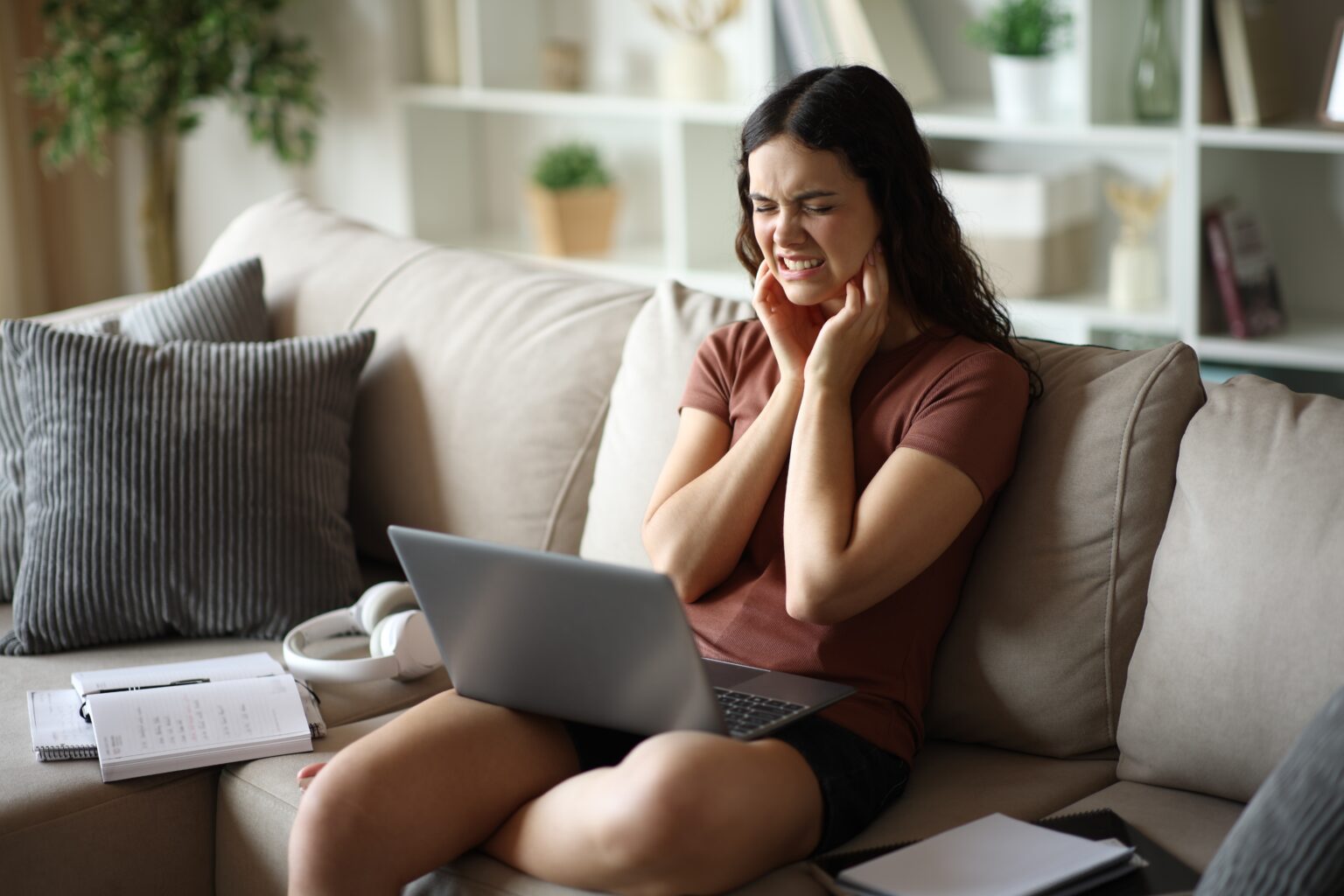 Student complaining of suffering while studying online while sitting on a couch